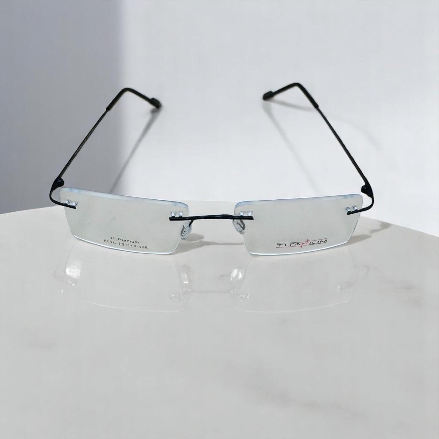 Rimless titanium frame glasses with wide, clear rectangular lenses